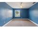 Simple bedroom with window, ceiling fan, and neutral carpet at 13005 Islamorada Dr, Orlando, FL 32837