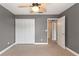 Simple bedroom with neutral walls, ceiling fan and closet at 13005 Islamorada Dr, Orlando, FL 32837