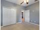 Spacious bedroom with neutral walls, carpet flooring, and ceiling fan at 13005 Islamorada Dr, Orlando, FL 32837
