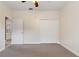 Simple bedroom with carpet, ceiling fan and double-door closet at 13005 Islamorada Dr, Orlando, FL 32837