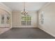 Spacious dining room with large window and chandelier at 13005 Islamorada Dr, Orlando, FL 32837