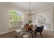 Bright dining room with a round table, chandelier, and bench seating at 13005 Islamorada Dr, Orlando, FL 32837