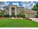 Two-story house with a three-car garage and manicured lawn at 13005 Islamorada Dr, Orlando, FL 32837