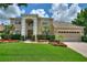 Two-story house with a three-car garage and manicured lawn at 13005 Islamorada Dr, Orlando, FL 32837