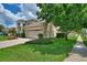 Two-story house with a large front yard, driveway, and mature trees at 13005 Islamorada Dr, Orlando, FL 32837