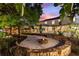 Stone fire pit surrounded by gravel and landscaping at 13005 Islamorada Dr, Orlando, FL 32837