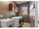 Laundry room with washer, dryer, cabinets, and utility sink at 13005 Islamorada Dr, Orlando, FL 32837