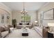Spacious living room with neutral colored sofas and a marble coffee table at 13005 Islamorada Dr, Orlando, FL 32837