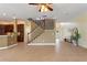 Spacious living room with tile floors and staircase at 13005 Islamorada Dr, Orlando, FL 32837