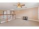 Open loft with neutral walls and carpeted floor at 13005 Islamorada Dr, Orlando, FL 32837