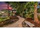 Lighted pathway winds through a beautifully landscaped garden at 13005 Islamorada Dr, Orlando, FL 32837