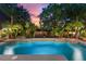 Inviting, lighted pool with surrounding landscaping at 13005 Islamorada Dr, Orlando, FL 32837