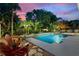 Relaxing pool area with lounge chairs and tropical plants at 13005 Islamorada Dr, Orlando, FL 32837