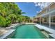 Large swimming pool with spacious patio and tropical landscaping at 13005 Islamorada Dr, Orlando, FL 32837