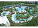 Aerial view of the sprawling resort with multiple pools, water slides, and lush landscaping at 14501 Grove Resort Ave # 1407, Winter Garden, FL 34787