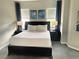 Comfortable bedroom featuring a king-sized bed with bedside tables and lamps at 14501 Grove Resort Ave # 1407, Winter Garden, FL 34787