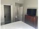 Bedroom with closet, and a view to the next room, featuring a television and dresser at 14501 Grove Resort Ave # 1407, Winter Garden, FL 34787