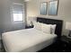 Bedroom featuring a comfortable king-size bed, with matching nightstands and wall art at 14501 Grove Resort Ave # 1407, Winter Garden, FL 34787
