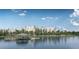 Waterfront resort and condo complex with private dock and lake access under a sunny partly cloudy sky at 14501 Grove Resort Ave # 1407, Winter Garden, FL 34787