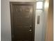 Apartment unit front door with new lock system and modern lighting fixture at 14501 Grove Resort Ave # 1407, Winter Garden, FL 34787