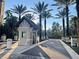 Well-maintained guard house at the entrance of a community with manicured landscaping and palm trees at 14501 Grove Resort Ave # 1407, Winter Garden, FL 34787