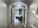 Arched hallway with view into living room and balcony at 14501 Grove Resort Ave # 1407, Winter Garden, FL 34787