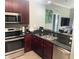 Updated kitchen with stainless steel appliances and dark granite countertops at 14501 Grove Resort Ave # 1407, Winter Garden, FL 34787