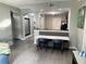 Open-concept living area featuring booth seating and a view of the kitchen at 14501 Grove Resort Ave # 1407, Winter Garden, FL 34787