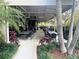 Relaxing outdoor restaurant patio with tropical landscaping, tables, and chairs at 14501 Grove Resort Ave # 1407, Winter Garden, FL 34787