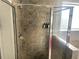 Tiled shower with glass door and wall-mounted toiletries for a spa-like experience at 14501 Grove Resort Ave # 1407, Winter Garden, FL 34787