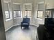 Cozy corner with comfortable armchair and ample natural light from multiple windows at 14501 Grove Resort Ave # 1407, Winter Garden, FL 34787