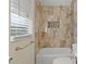 Updated bathroom with tub, shower, and modern vanity at 1609 Stocking St, Daytona Beach, FL 32117