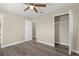 Bright bedroom with ceiling fan, wood-look floors, and spacious closet at 1609 Stocking St, Daytona Beach, FL 32117