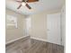 Bedroom with ceiling fan, wood-look floors, and window with blinds at 1609 Stocking St, Daytona Beach, FL 32117