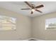 Bedroom with two windows, ceiling fan, and wood floors at 1609 Stocking St, Daytona Beach, FL 32117