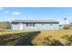 Back of house with large yard and fenced area at 1609 Stocking St, Daytona Beach, FL 32117