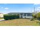 House exterior with light blue paint, white trim, and landscaping at 1609 Stocking St, Daytona Beach, FL 32117
