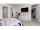 Bedroom with white dresser, large TV, and walk-in closet at 2033 Canny Cv, Winter Park, FL 32792