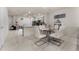 Modern dining area with glass-top table and white leather chairs at 2033 Canny Cv, Winter Park, FL 32792