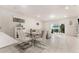 Bright dining area with glass table, white chairs, and view of the living room at 2033 Canny Cv, Winter Park, FL 32792