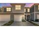 Modern two-story townhome with gray siding, two-car garage, and walkway at 2033 Canny Cv, Winter Park, FL 32792