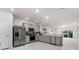 Spacious kitchen featuring gray cabinets, stainless steel appliances, and an island at 2033 Canny Cv, Winter Park, FL 32792