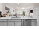 Modern kitchen with quartz countertops, stainless steel dishwasher, and open layout at 2033 Canny Cv, Winter Park, FL 32792