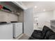 Convenient upper-level laundry room with washer, dryer and shelving at 2033 Canny Cv, Winter Park, FL 32792