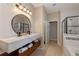 Double vanity bathroom with floating cabinets and large mirror at 2158 Stillwood Way, St Cloud, FL 34771
