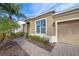 Tan house with a two-car garage and walkway at 2158 Stillwood Way, St Cloud, FL 34771