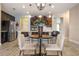 Kitchen nook with a small round table and four light beige chairs at 2158 Stillwood Way, St Cloud, FL 34771