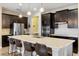 Modern kitchen with dark cabinets, island, and stainless steel appliances at 2158 Stillwood Way, St Cloud, FL 34771