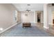 Bright living room featuring hardwood floors and a view into the kitchen and dining area at 2158 Stillwood Way, St Cloud, FL 34771