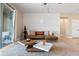 Living area featuring a brown leather sectional sofa and white accent wall at 2158 Stillwood Way, St Cloud, FL 34771